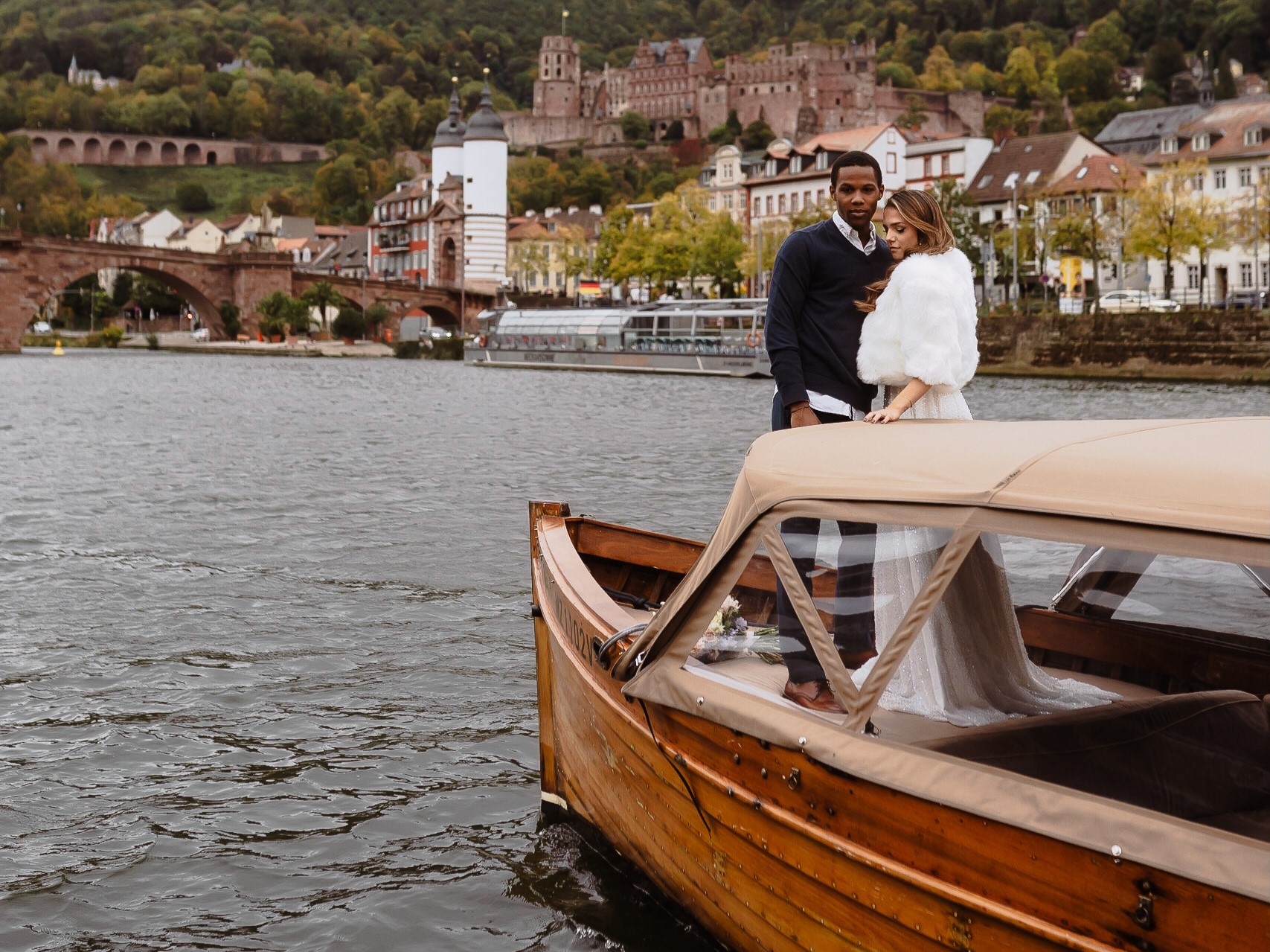 A couple at their after wedding shoot on board one of Riverboat's boats with the Heidelberg Castle as backdrop
